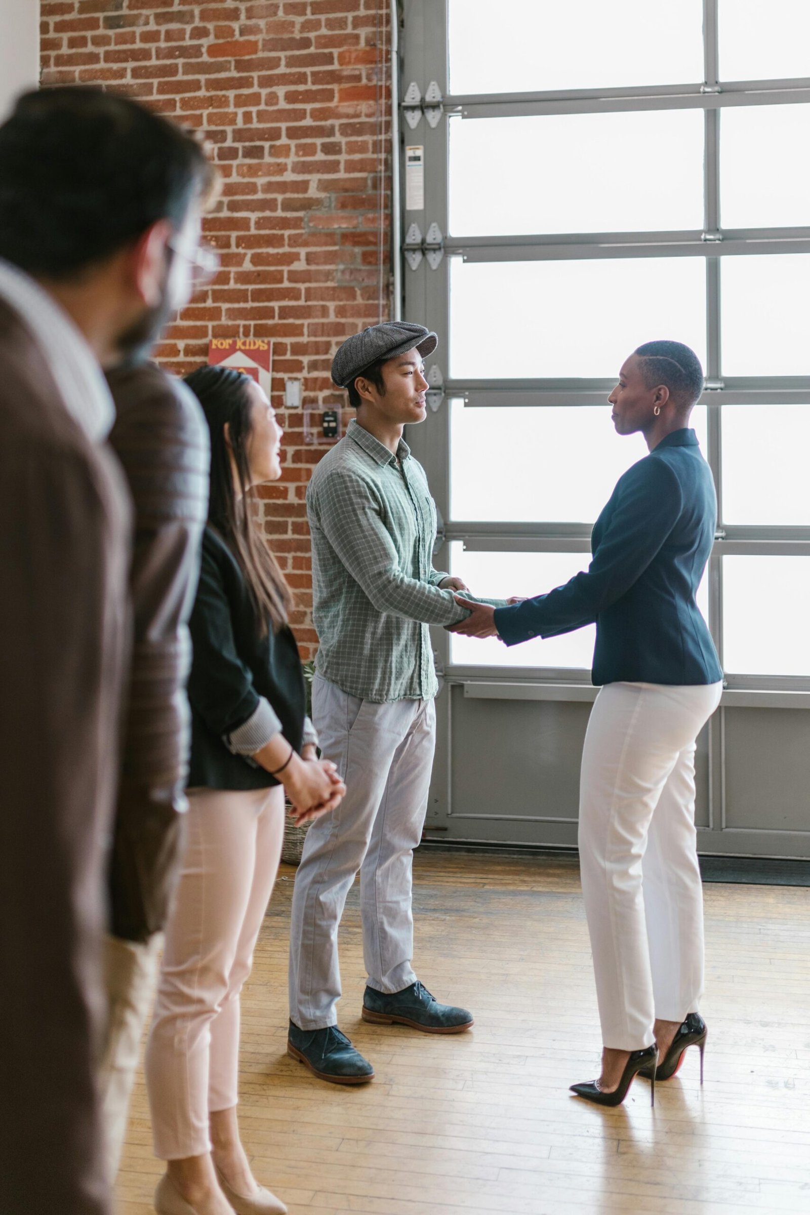 pexels-photo-7414002-7414002 Group of professionals in modern office shaking hands after successful collaboration